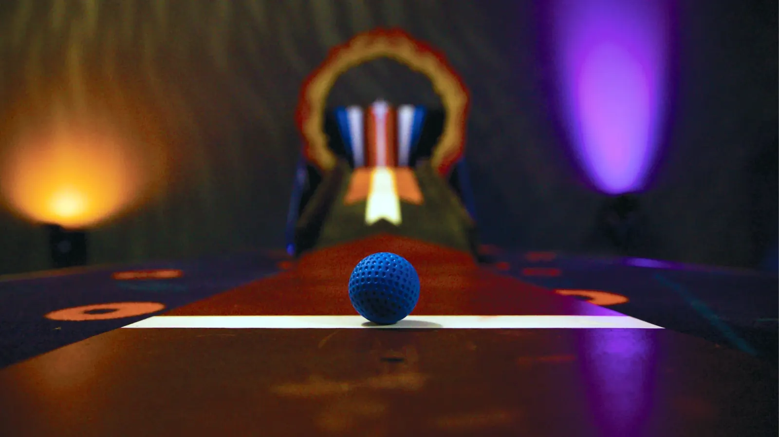 Mini golf lane glowing with warm light
