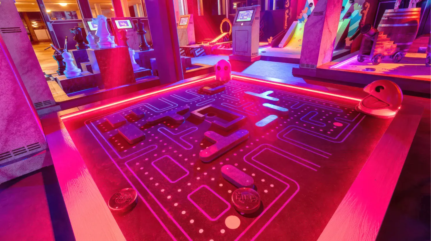 Neon-lit MindGolf lane with giant chess pieces